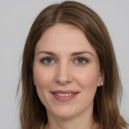 Joyful white young-adult female with long  brown hair and grey eyes