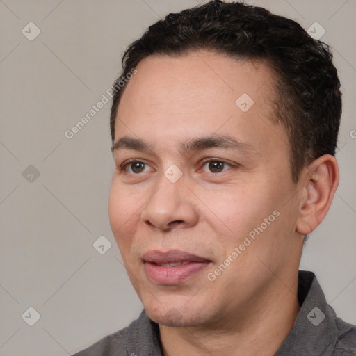 Joyful white adult male with short  black hair and brown eyes