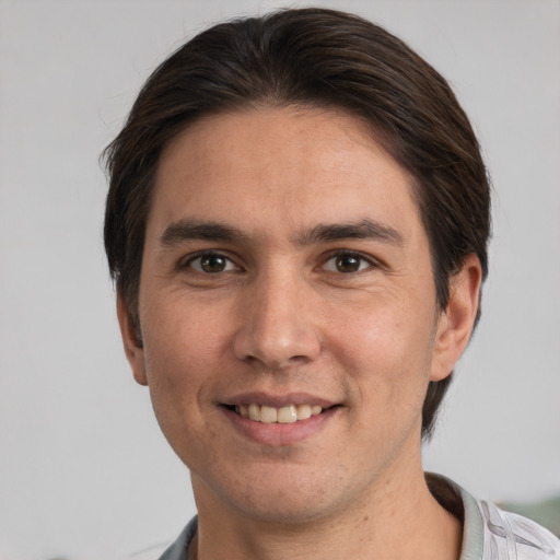 Joyful white adult male with short  brown hair and brown eyes