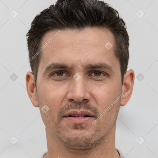 Joyful white adult male with short  brown hair and brown eyes