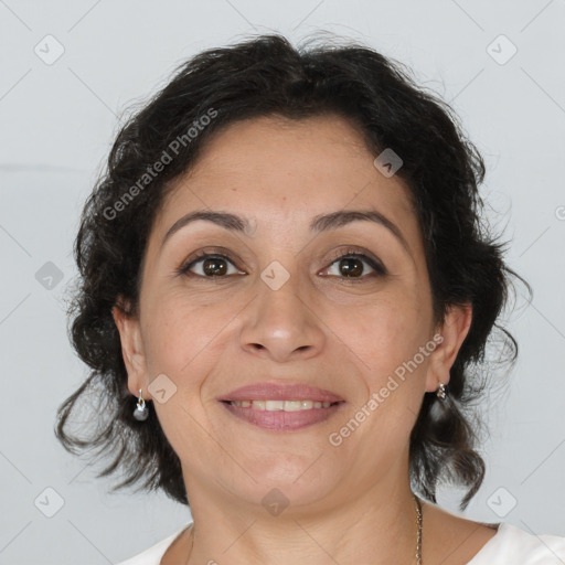 Joyful latino adult female with medium  brown hair and brown eyes