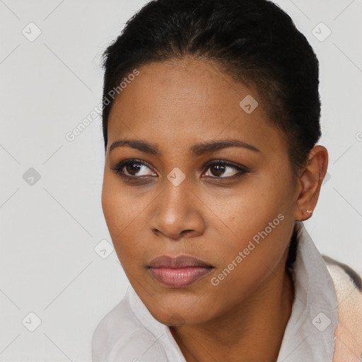 Joyful black young-adult female with short  brown hair and brown eyes