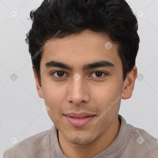 Joyful latino young-adult male with short  brown hair and brown eyes