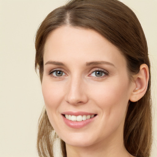 Joyful white young-adult female with long  brown hair and grey eyes