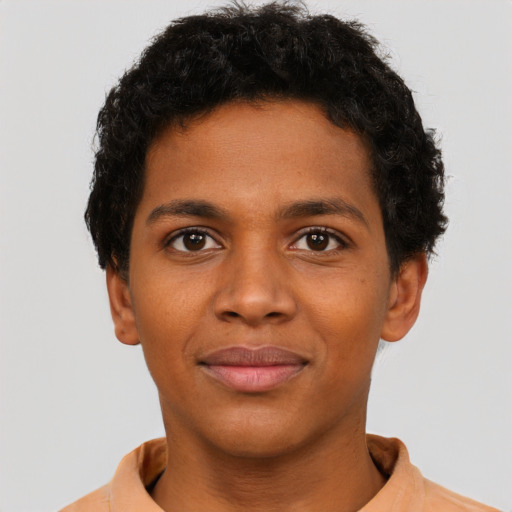 Joyful black young-adult male with short  brown hair and brown eyes