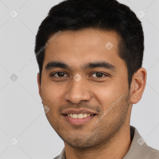 Joyful latino young-adult male with short  black hair and brown eyes