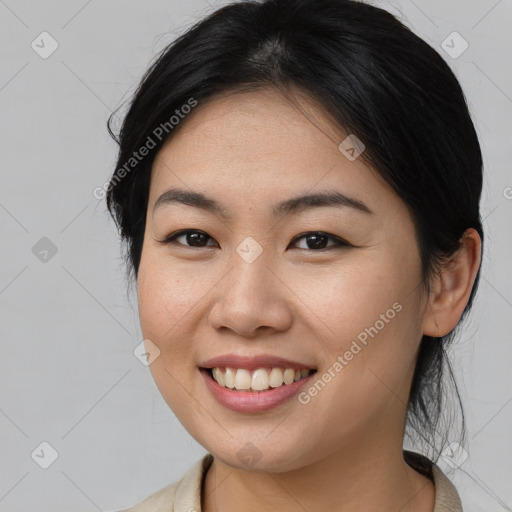 Joyful asian young-adult female with medium  brown hair and brown eyes