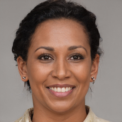 Joyful latino adult female with medium  brown hair and brown eyes