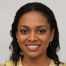 Joyful latino young-adult female with long  brown hair and brown eyes