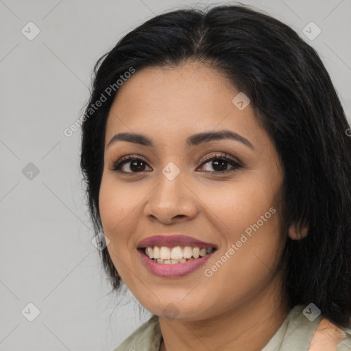 Joyful latino young-adult female with long  black hair and brown eyes