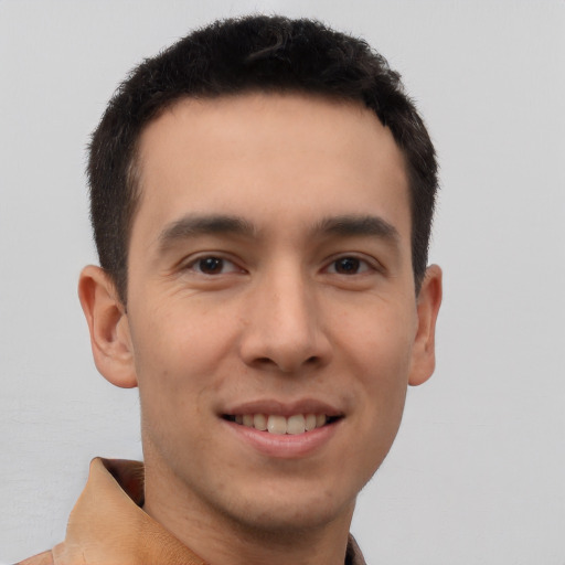 Joyful latino young-adult male with short  brown hair and brown eyes