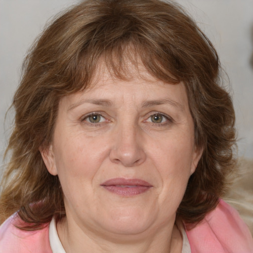 Joyful white adult female with medium  brown hair and blue eyes