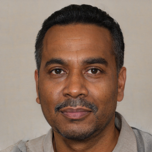 Neutral black adult male with short  black hair and brown eyes