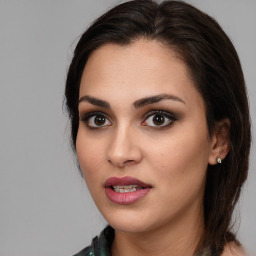 Joyful white young-adult female with medium  brown hair and brown eyes