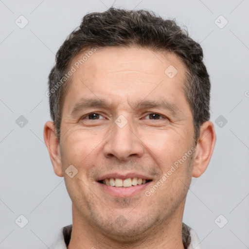 Joyful white adult male with short  brown hair and brown eyes