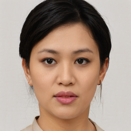 Joyful asian young-adult female with medium  black hair and brown eyes