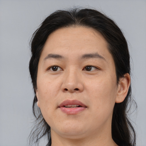 Joyful asian adult female with medium  brown hair and brown eyes