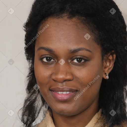 Joyful black young-adult female with long  black hair and brown eyes