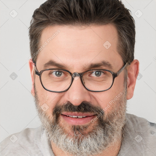 Joyful white adult male with short  brown hair and grey eyes