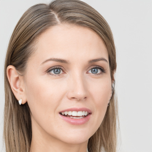 Joyful white young-adult female with long  brown hair and blue eyes