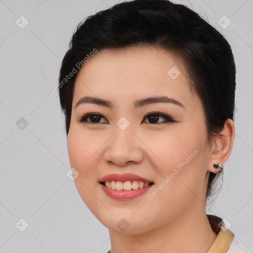 Joyful asian young-adult female with medium  black hair and brown eyes