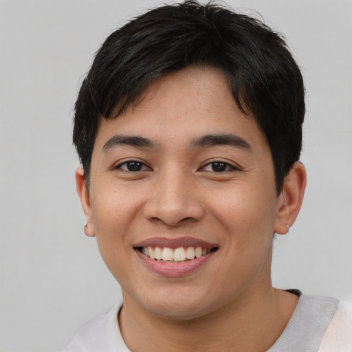 Joyful asian young-adult male with short  brown hair and brown eyes