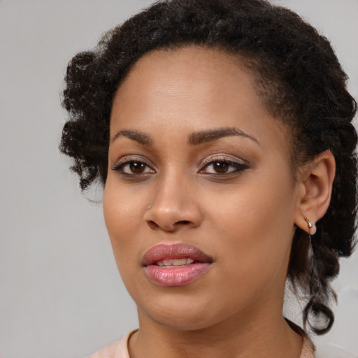 Joyful black young-adult female with medium  brown hair and brown eyes