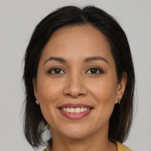 Joyful white adult female with medium  brown hair and brown eyes