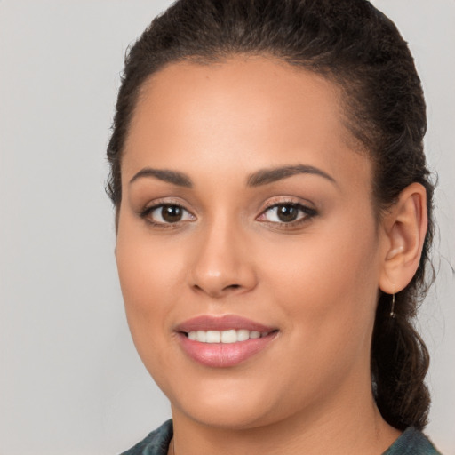 Joyful white young-adult female with long  brown hair and brown eyes