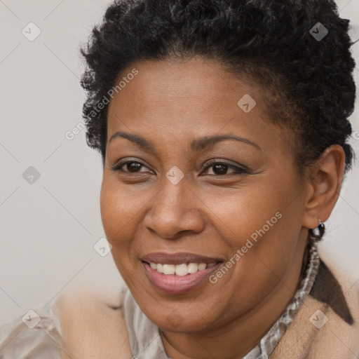 Joyful black adult female with short  brown hair and brown eyes