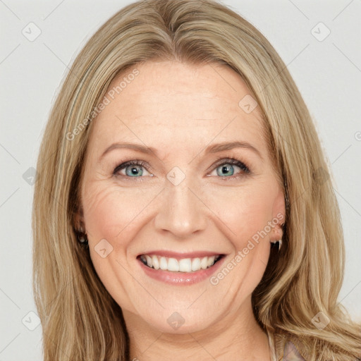 Joyful white adult female with long  brown hair and green eyes