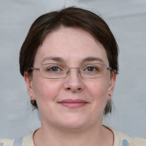 Joyful white young-adult female with medium  brown hair and blue eyes