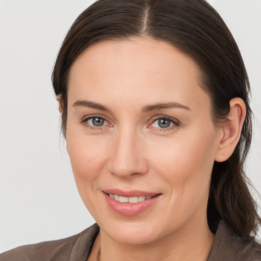 Joyful white adult female with medium  brown hair and brown eyes