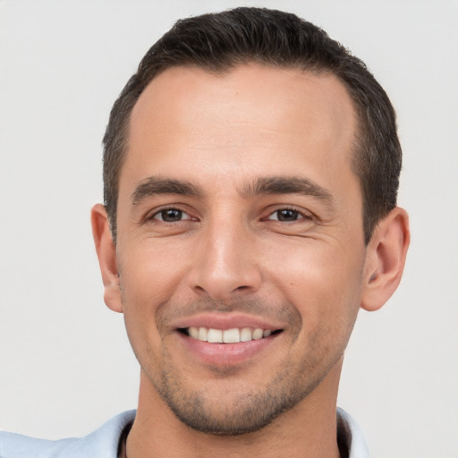 Joyful white young-adult male with short  brown hair and brown eyes