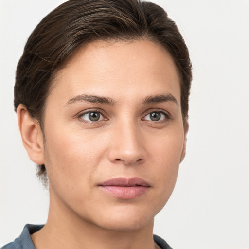 Joyful white young-adult female with short  brown hair and grey eyes