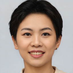 Joyful asian young-adult female with short  brown hair and brown eyes