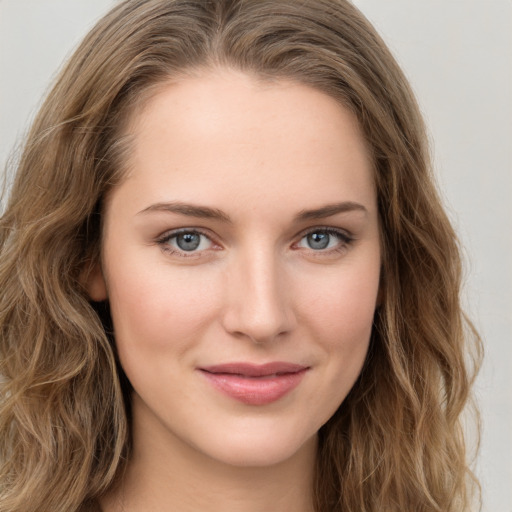 Joyful white young-adult female with long  brown hair and green eyes