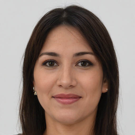 Joyful latino young-adult female with long  brown hair and brown eyes