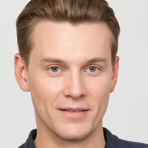 Joyful white young-adult male with short  brown hair and grey eyes