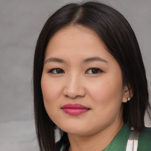 Joyful asian young-adult female with long  brown hair and brown eyes
