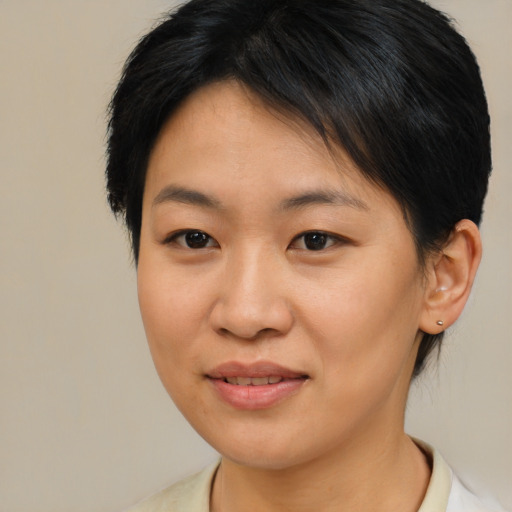 Joyful asian young-adult female with medium  brown hair and brown eyes