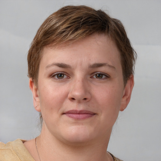 Joyful white young-adult female with short  brown hair and grey eyes