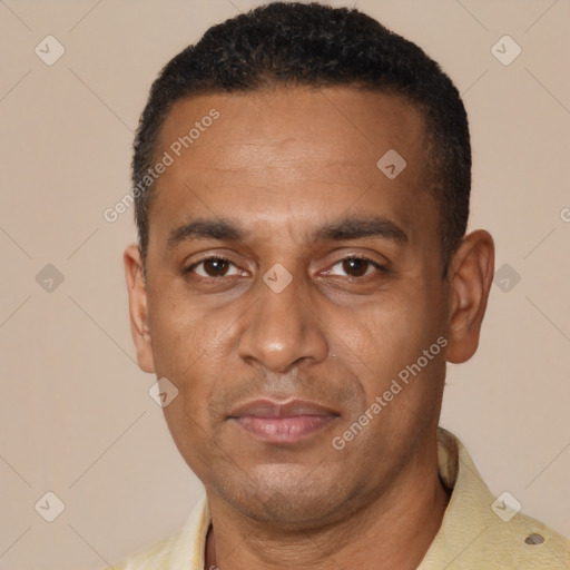 Joyful black adult male with short  black hair and brown eyes