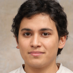 Joyful latino young-adult male with short  brown hair and brown eyes