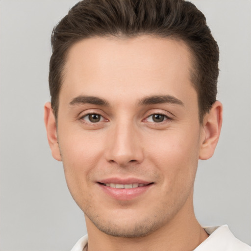 Joyful white young-adult male with short  brown hair and brown eyes