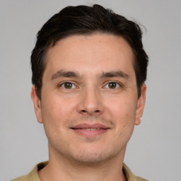 Joyful white young-adult male with short  brown hair and brown eyes