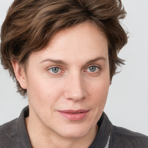 Joyful white young-adult female with medium  brown hair and blue eyes