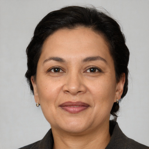 Joyful latino adult female with medium  brown hair and brown eyes