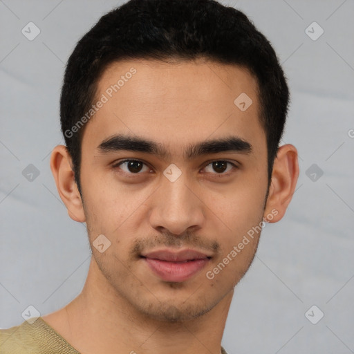 Joyful latino young-adult male with short  brown hair and brown eyes