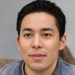 Joyful asian young-adult male with short  brown hair and brown eyes